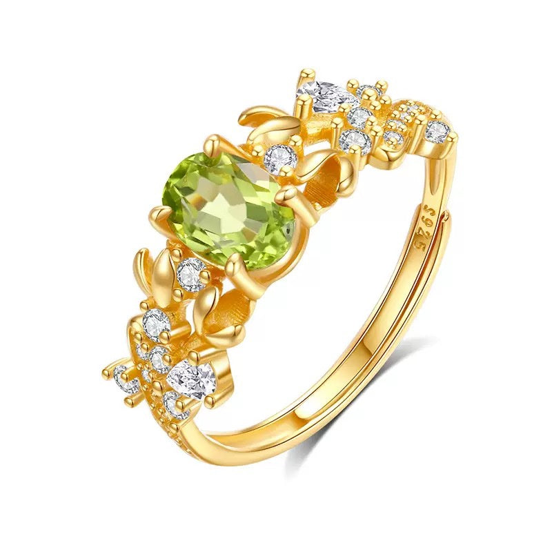 Bauhinia ring with peridot stone on white background