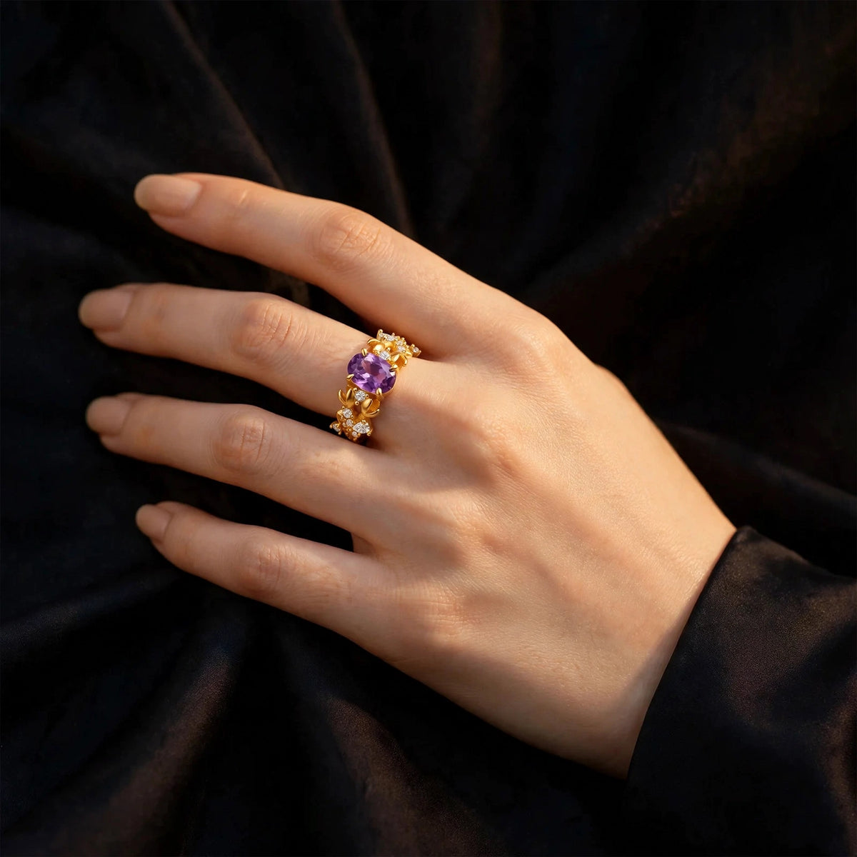 Bauhinia ring with amethyst worn on a hand