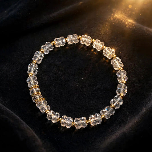 Clear crystal bracelet with gold spacers on dark velvet