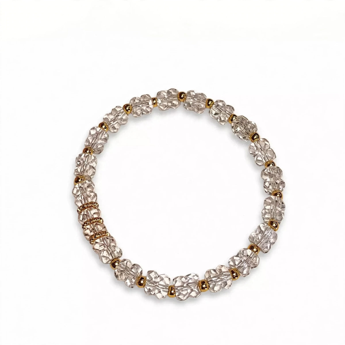 Clear crystal bracelet with gold spacers on white background